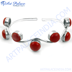 Load image into Gallery viewer, Silver bangle bracelet with red coral stones, a statement piece of jewelry.
