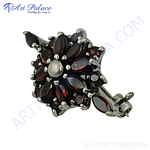 Load image into Gallery viewer, 925 sterling silver stud earrings featuring a floral design with garnet gemstones and a silver accent.
