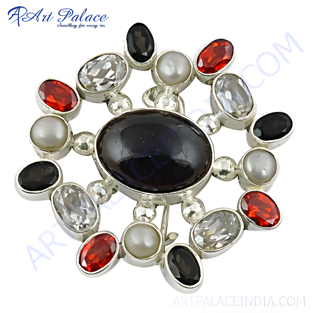 Sterling silver brooch with oval black gemstone center and surrounding red, white and black stones, and pearls.