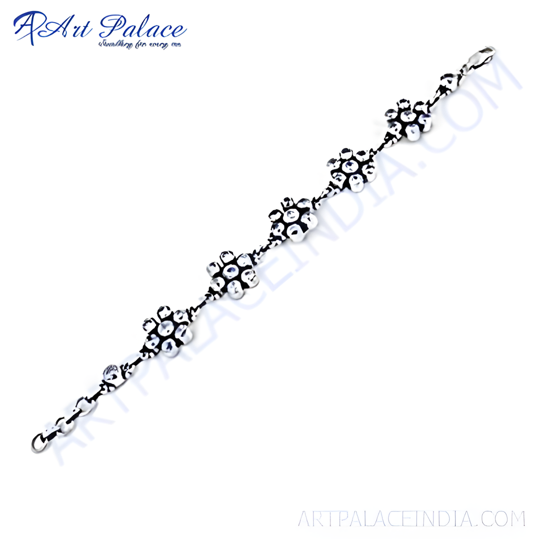 925 sterling silver flower motif bracelet, linked chain design, white background.