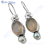 Load image into Gallery viewer, Sterling silver drop earrings featuring moonstone and pearl gemstones in a unique design.
