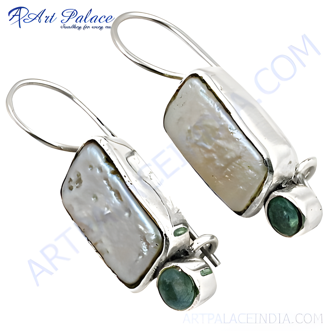 Sterling silver dangle earrings with large white pearl and small round emerald gemstones.