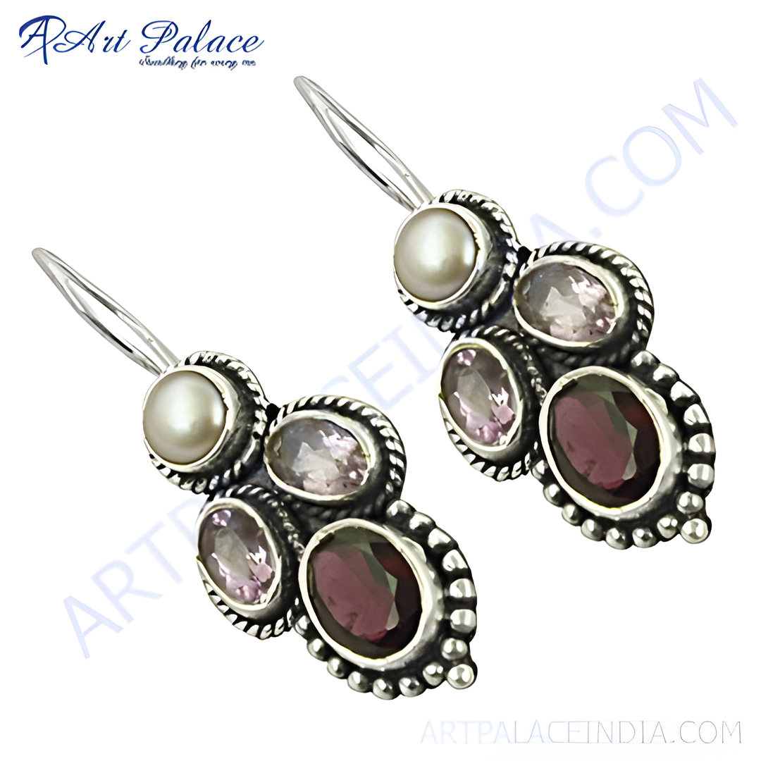 Sterling silver drop earrings featuring pearl and gemstone accents in a dangle design.