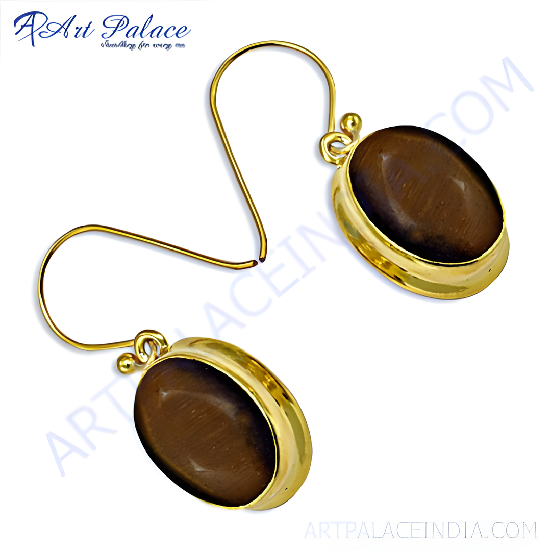 Gold dangle earrings featuring oval-shaped tiger eye gemstones in a gold setting.