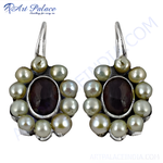 Load image into Gallery viewer, Sterling silver drop earrings with white pearls and a central dark gemstone design.
