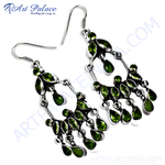 Load image into Gallery viewer, Sterling silver chandelier earrings featuring vibrant green peridot gemstones and a secure hook closure.
