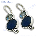 Load image into Gallery viewer, 925 sterling silver dangle earrings with blue gemstone and smaller clear stone accents.
