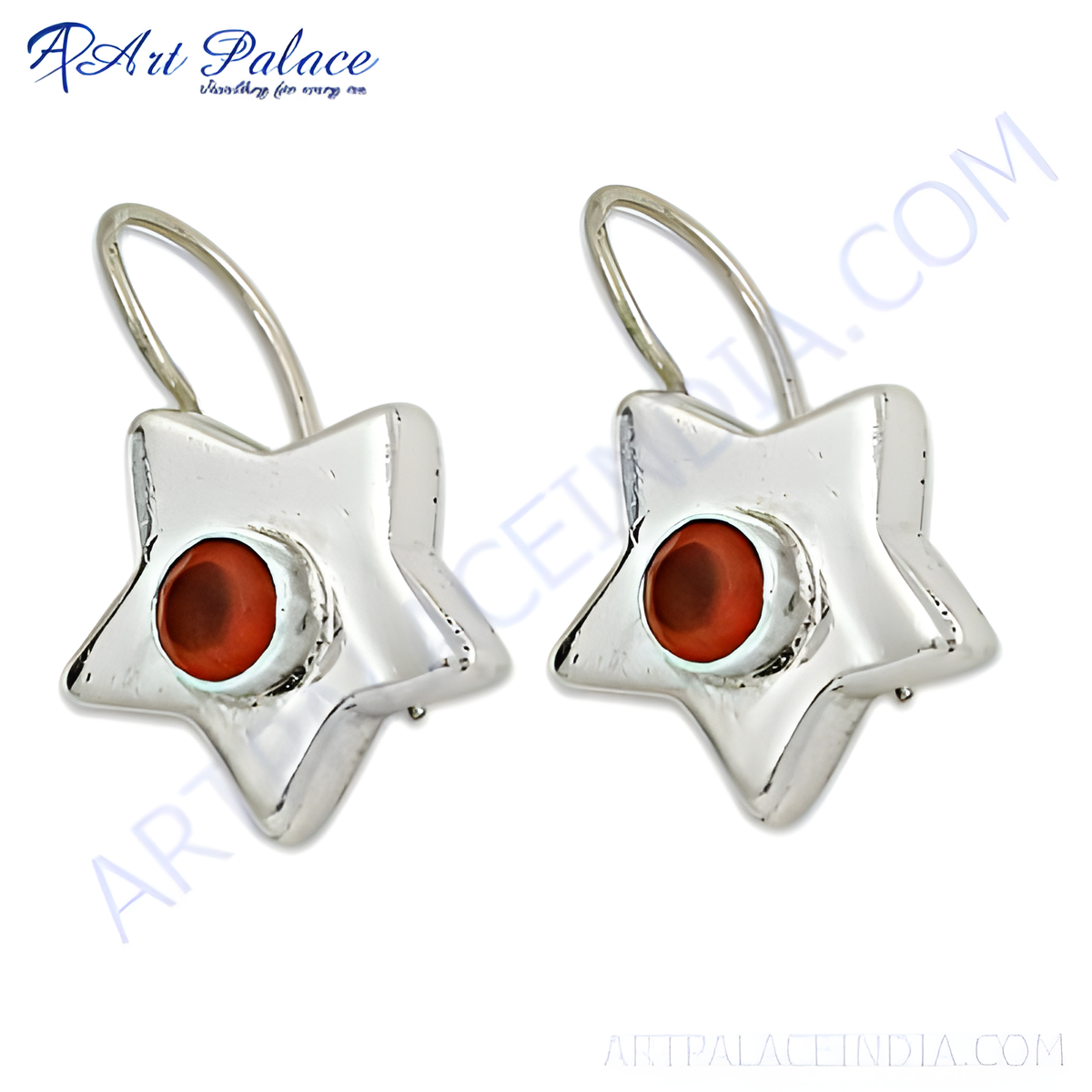 Sterling silver dangle earrings with a star shape and a red gemstone center