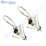 Load image into Gallery viewer, Sterling silver dangle earrings with a triangle design and a round red garnet gemstone.
