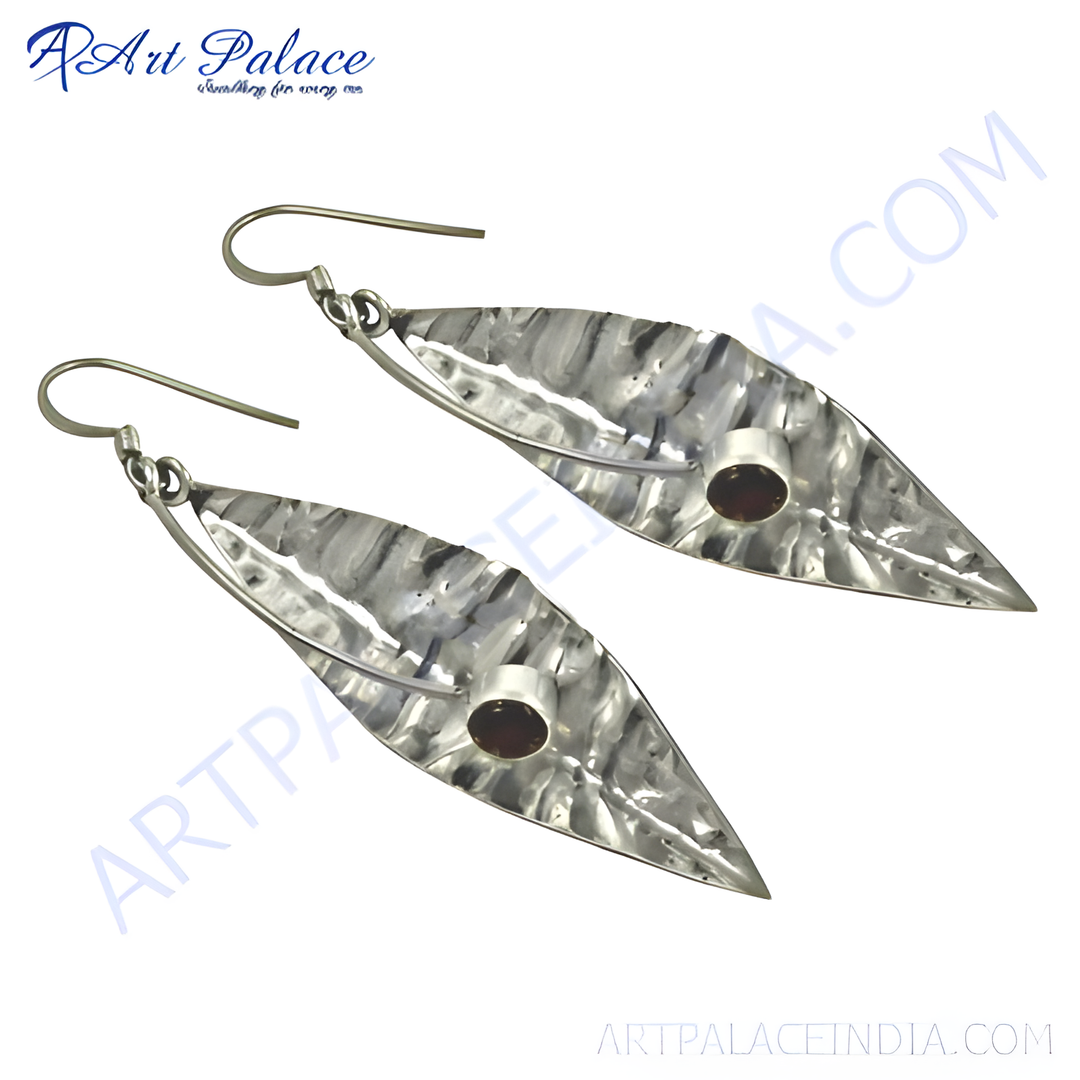 925 sterling silver dangle earrings featuring a leaf design with a hammered texture and a round garnet gemstone center.