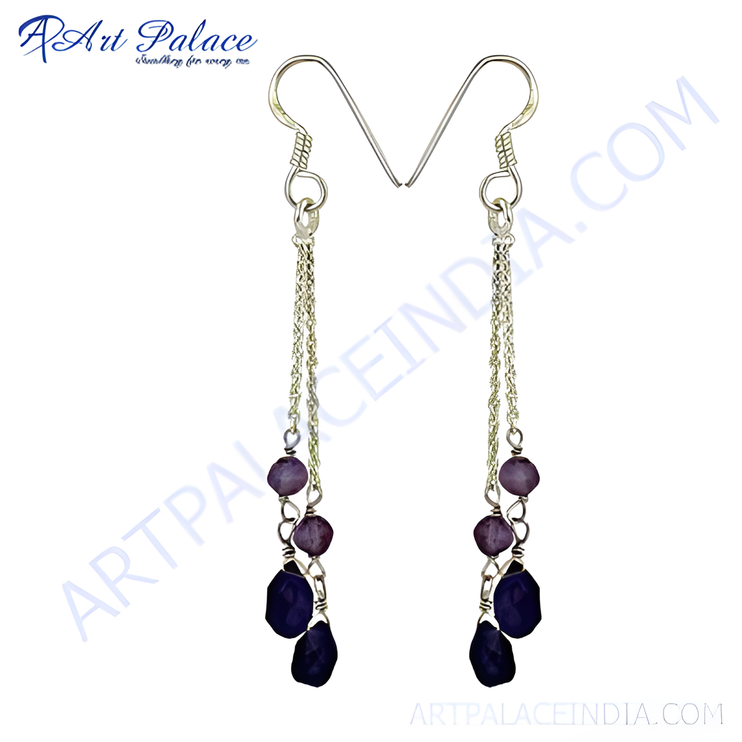 Sterling silver dangle earrings with faceted purple gemstones hanging from the hook.
