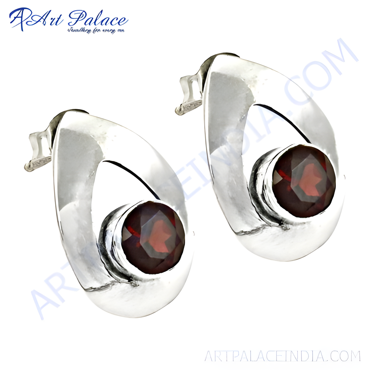 Sterling silver stud earrings with a teardrop design featuring a round, red garnet gemstone center