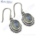 Load image into Gallery viewer, Sterling silver dangle earrings with oval moonstone gemstones and an intricate design, perfect for women's jewelry.
