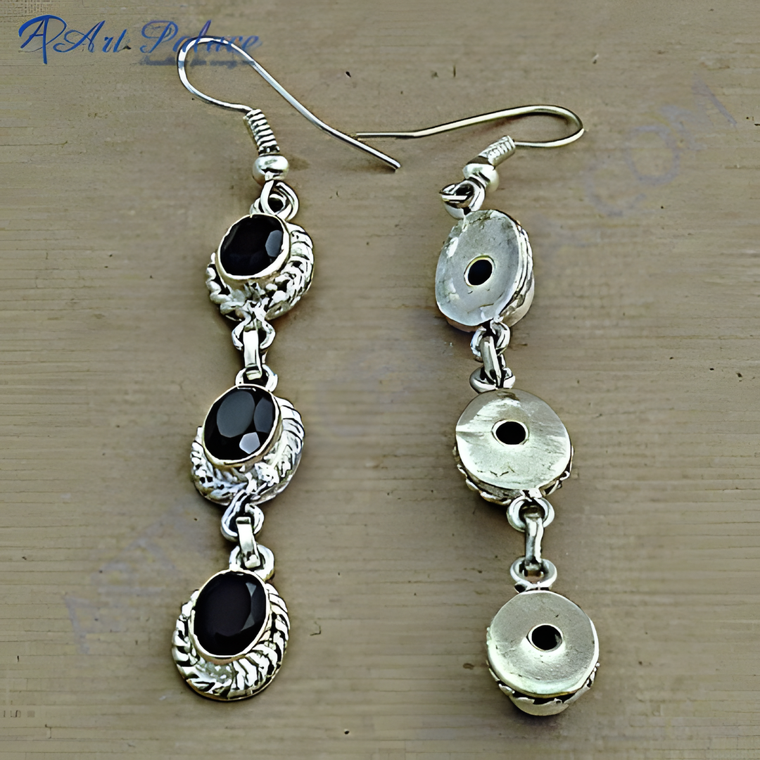 Sterling silver dangle earrings with three black onyx gemstones, perfect for everyday wear.