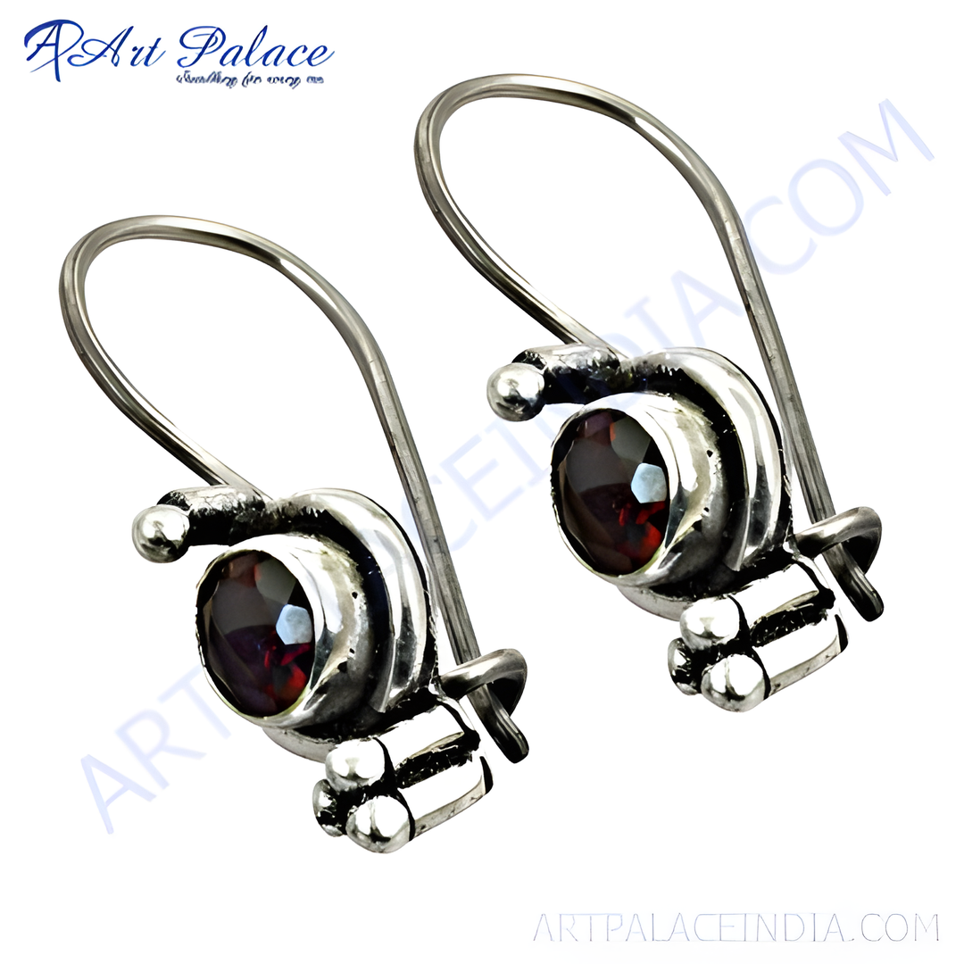 925 sterling silver dangle earrings featuring round-cut red garnet gemstones.