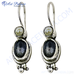 Load image into Gallery viewer, Sterling silver dangle earrings with a pearl and a dark oval gemstone.
