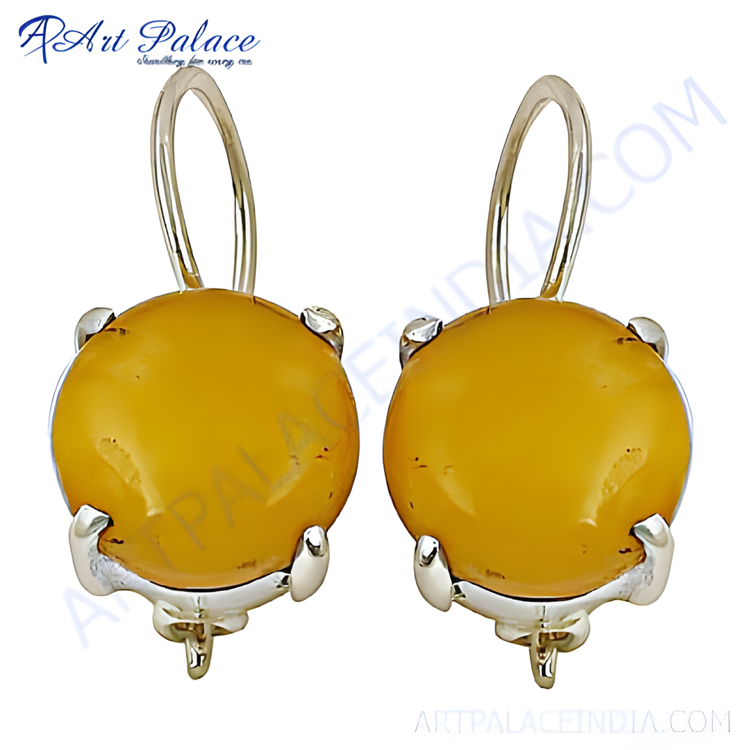 Silver drop earrings with round, yellow amber gemstones and hook closures.