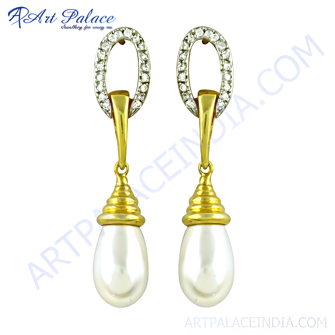 Gold drop earrings with white pearl drops and a diamond-like accent on top.