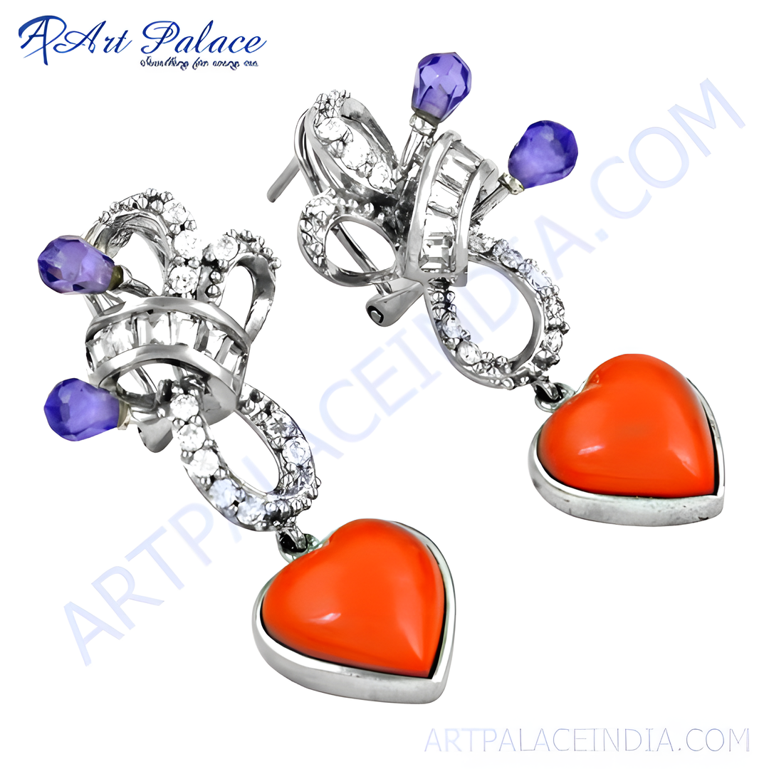 Silver dangle earrings with heart-shaped red gemstones and purple accents.