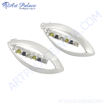 Load image into Gallery viewer, Silver leaf shaped stud earrings with a line of green and black stones, showcasing a sleek and modern design.
