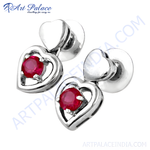 Load image into Gallery viewer, Sterling silver stud earrings with heart design and a vibrant red ruby gemstone.

