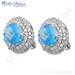 Load image into Gallery viewer, Silver stud earrings with a large blue gemstone center and surrounding smaller clear gemstones.
