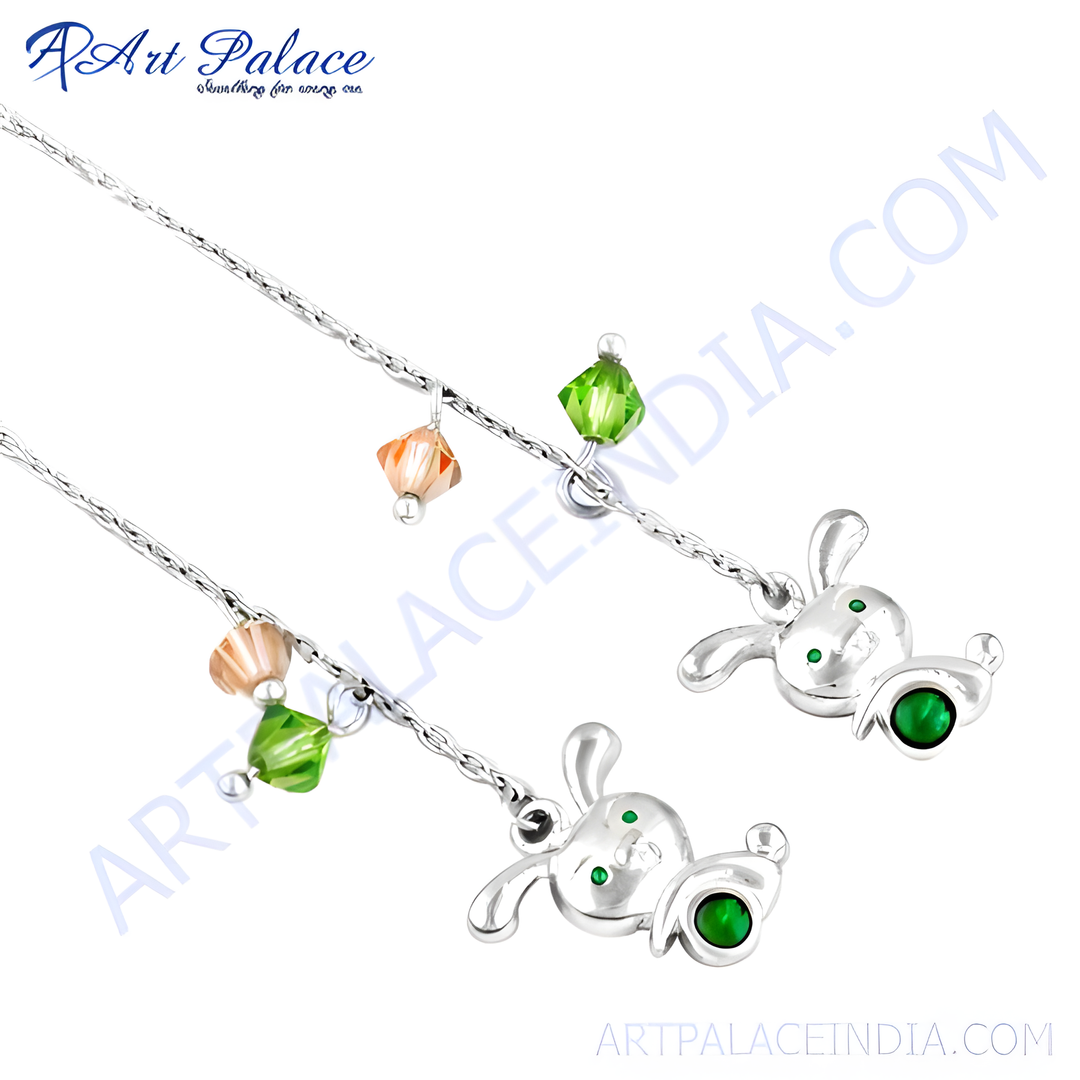 Sterling silver charm bracelet with bunny charms and green gemstone accents.