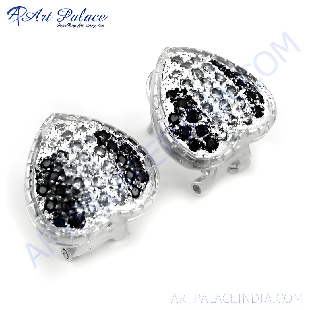Silver heart stud earrings with black and white gemstones. Elegant fashion jewelry.