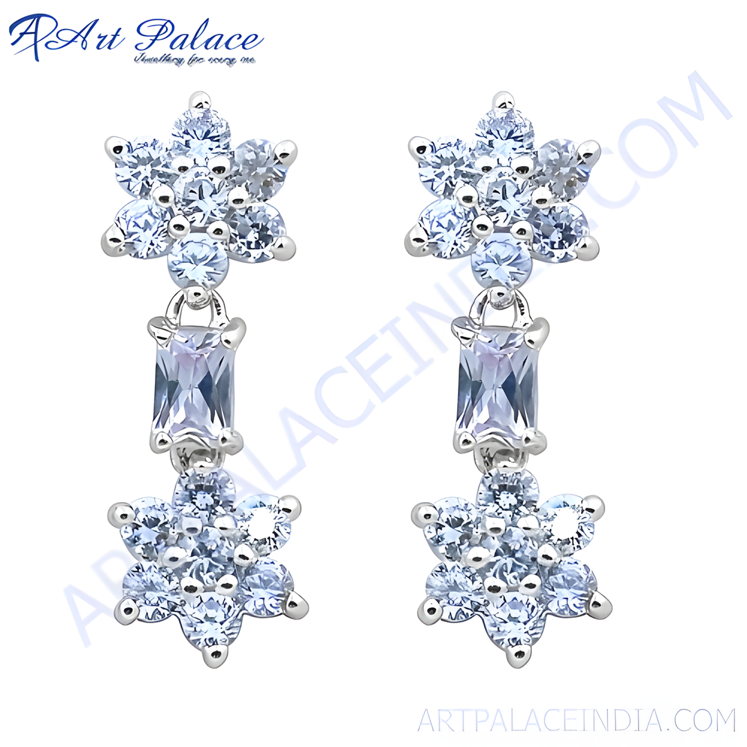 Silver drop earrings featuring a flower design and sparkling cubic zirconia stones.
