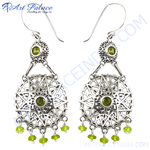Load image into Gallery viewer, Sterling silver dangle earrings with peridot gemstones. Features a detailed filigree design and a secure hook closure.
