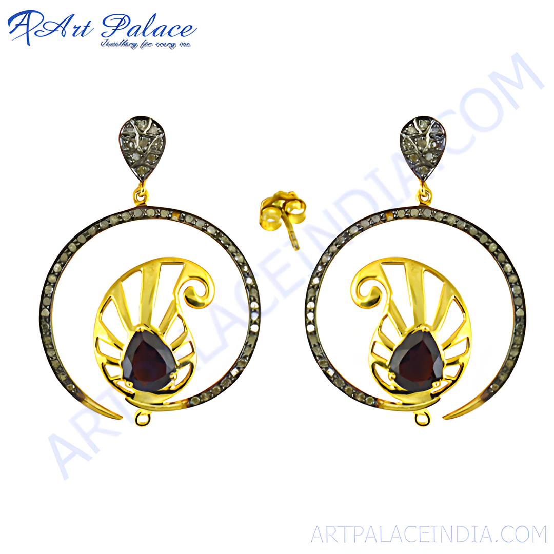 Gold filigree dangle earrings featuring a dark red garnet gemstone and sparkling details
