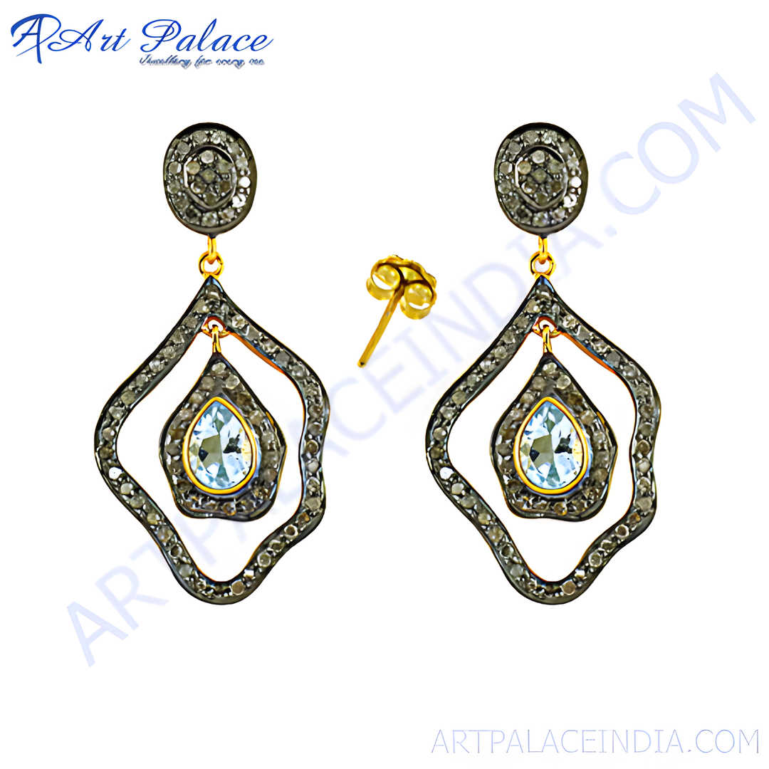 Elegant drop earrings featuring aquamarine gemstones and diamond accents, set in a gold and dark metal frame, perfect for special occasions.