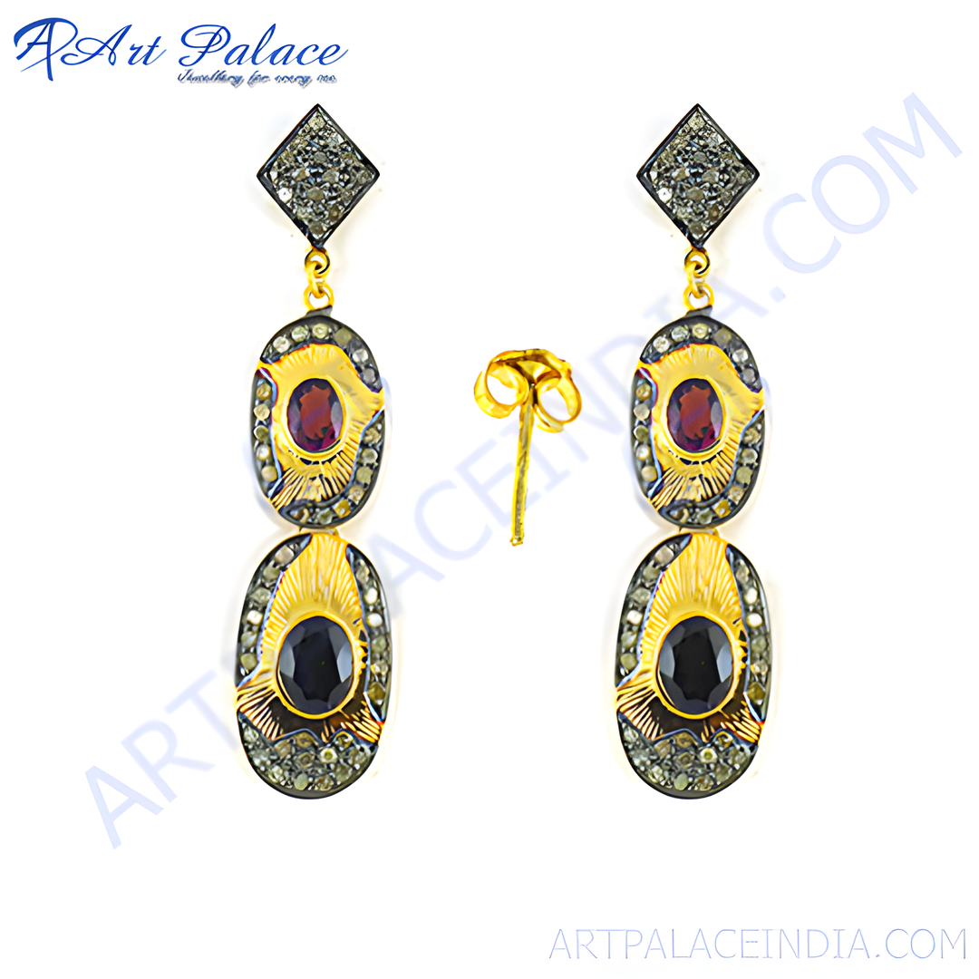 Gold dangle earrings featuring ruby and sapphire gemstones. Elegant and luxurious design perfect for gifting.