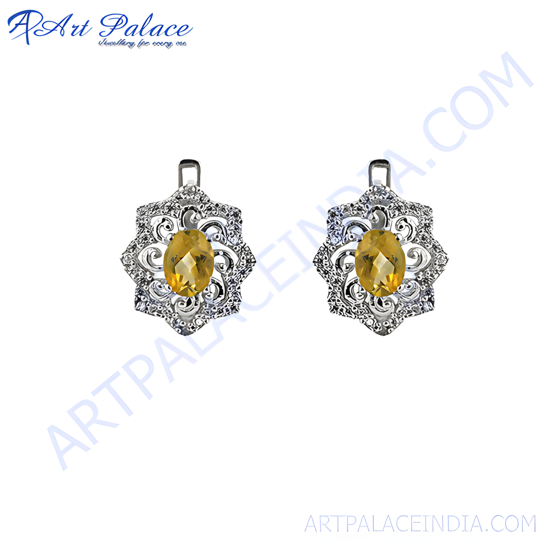 925 sterling silver stud earrings with a central oval-cut citrine gemstone. Features a floral design.