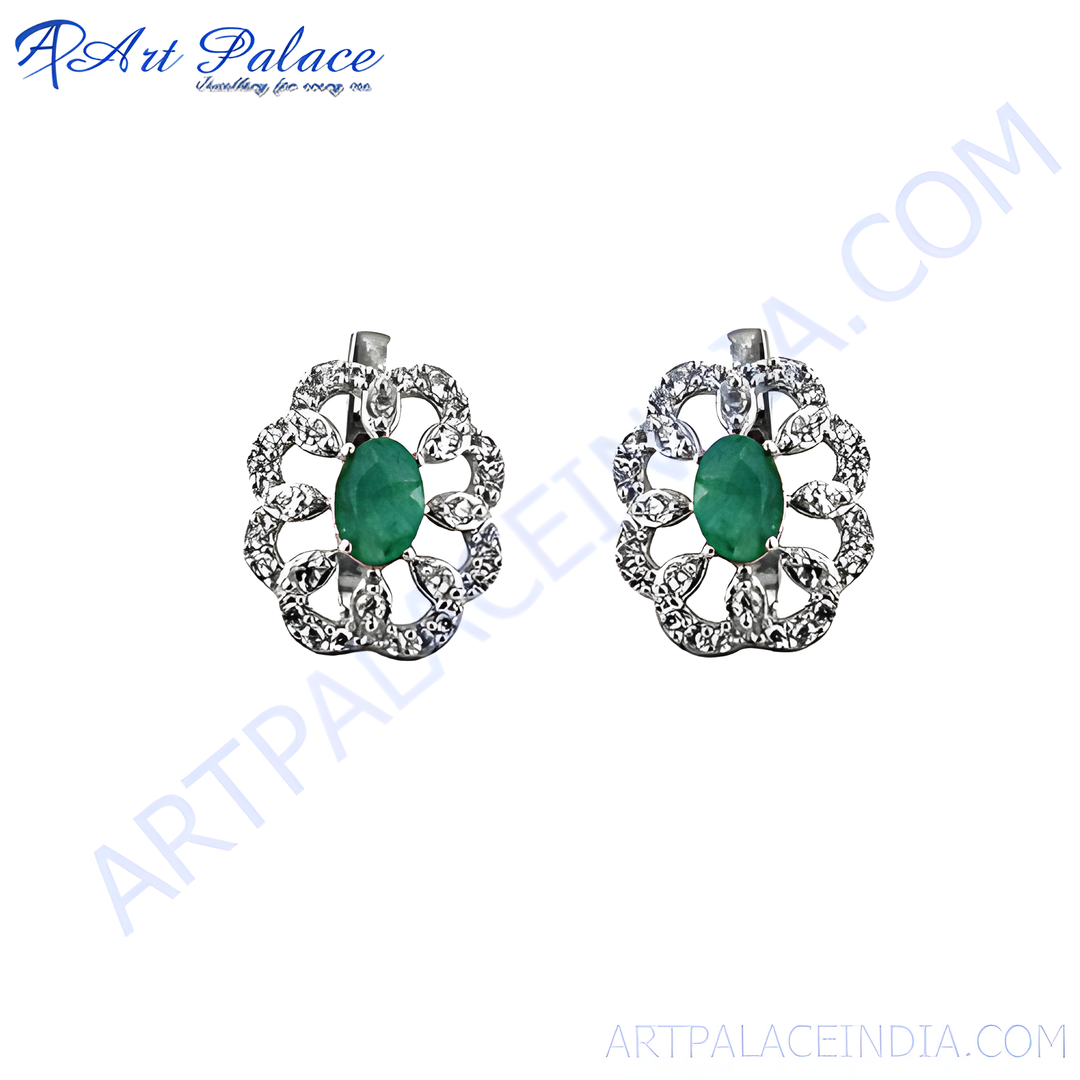 Sterling silver stud earrings featuring oval emeralds and sparkling diamonds in a floral design.