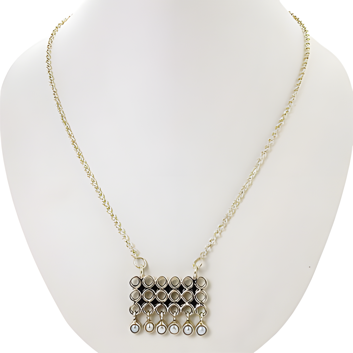Silver geometric pendant necklace on a white mannequin