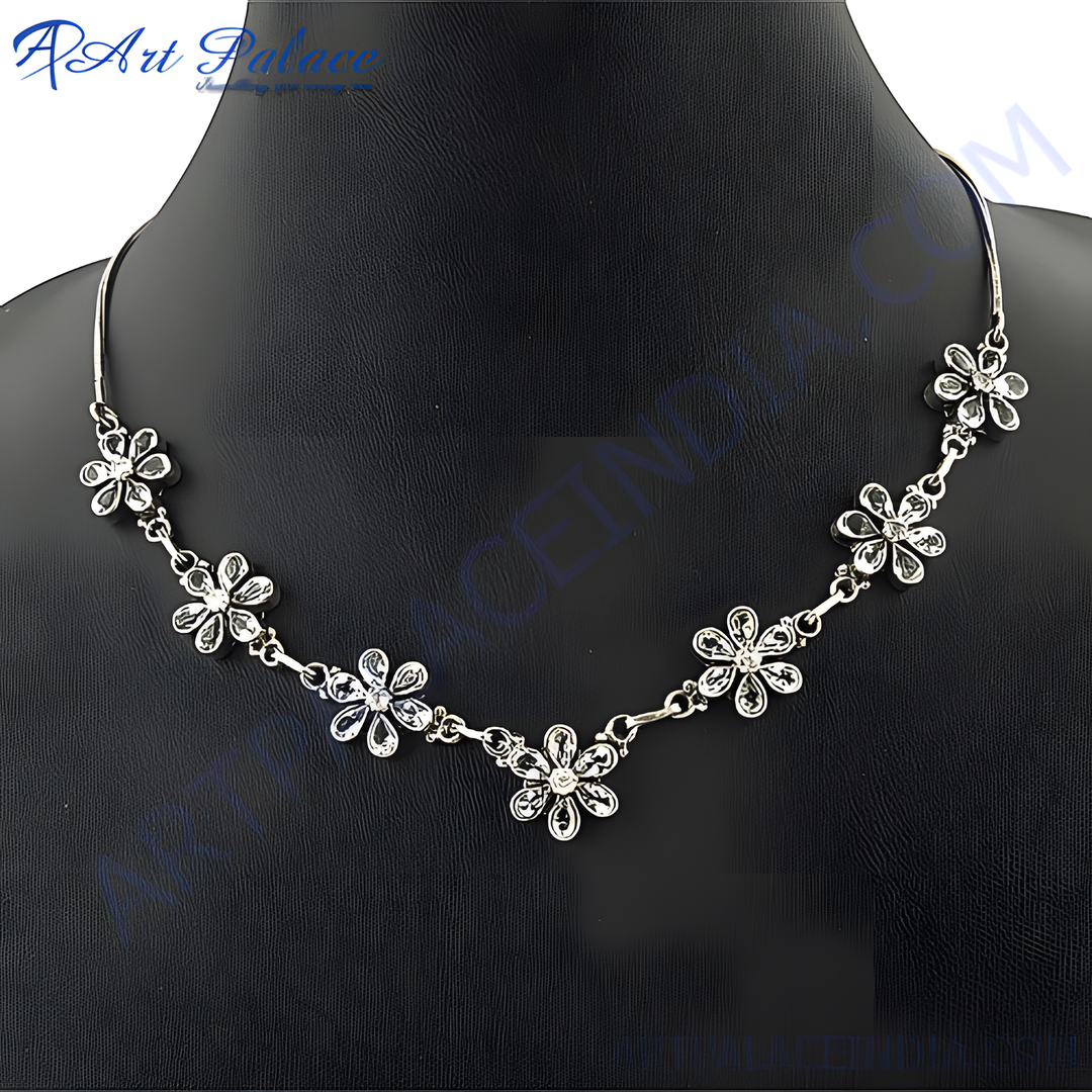 Silver floral necklace with sparkling crystals on a black mannequin.