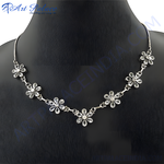 Load image into Gallery viewer, Silver floral necklace with sparkling crystals on a black mannequin.
