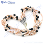 Load image into Gallery viewer, Multi-strand necklace with pink pearls and black onyx beads on white background
