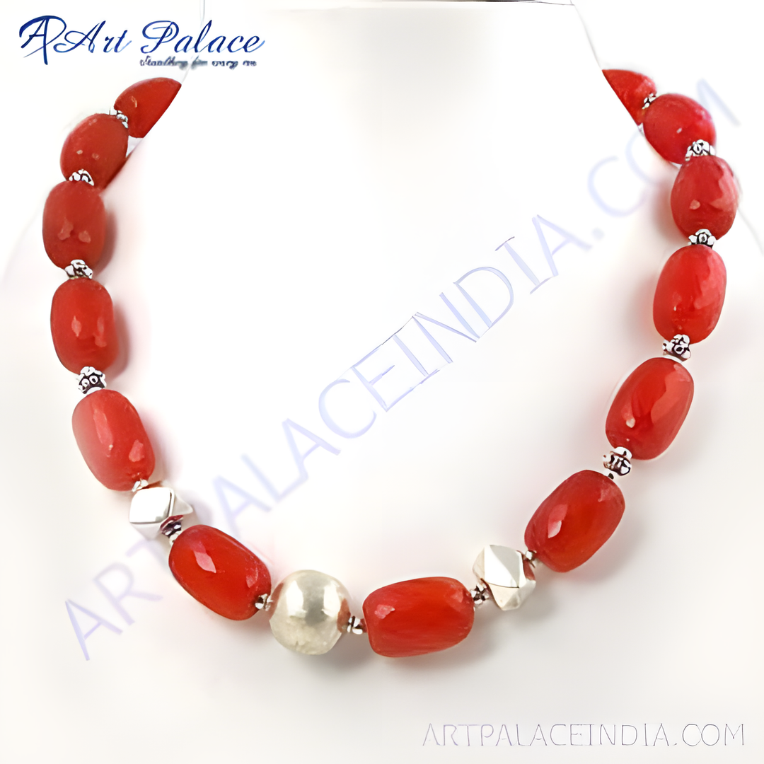Red agate bead necklace with sterling silver accents on a white background, highlighting the gemstone and silver beads.