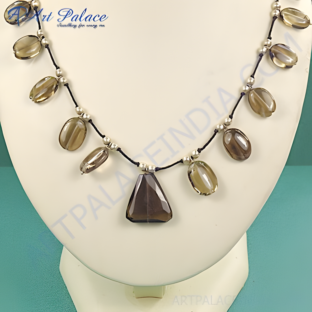 Smoky quartz pendant necklace featuring a triangular pendant and oval gemstones on a black cord.