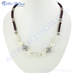 Load image into Gallery viewer, A beaded necklace with a combination of gemstones and silver accents on a white jewelry display.
