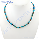 Load image into Gallery viewer, Turquoise bead necklace displayed on a mannequin, featuring turquoise and brown beads with silver accents.
