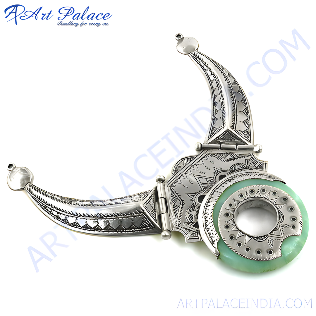 Silver pendant necklace with green stone, featuring a unique tribal design and intricate details.