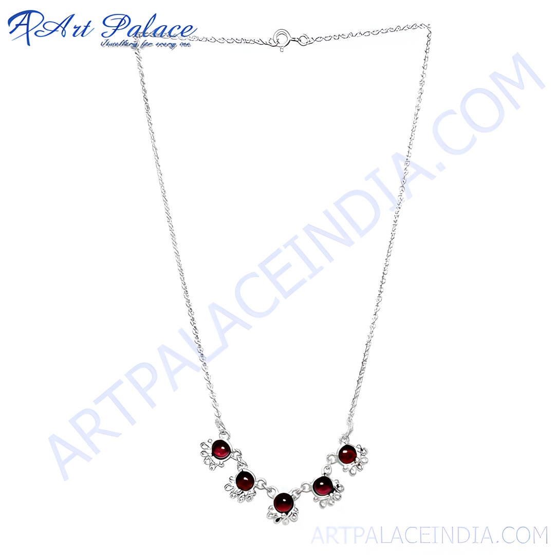 Sterling silver necklace with red garnet gemstones, elegant floral design.