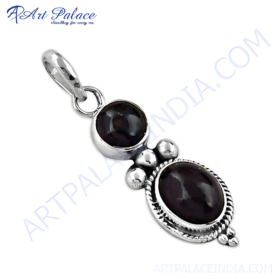 Sterling silver pendant featuring two oval and round dark red garnet gemstones set against a white background.