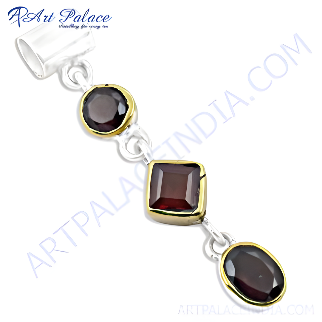 Sterling silver pendant with three red garnet gemstones. Round, square, and oval cut, gold plating-plated bezel.