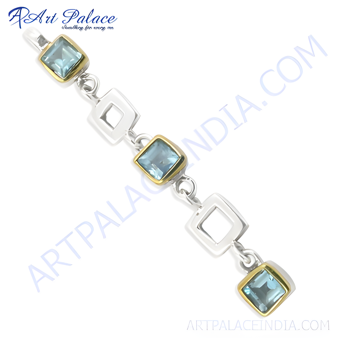 Sterling silver chain bracelet with blue topaz gemstones and gold plating accents, elegant design.