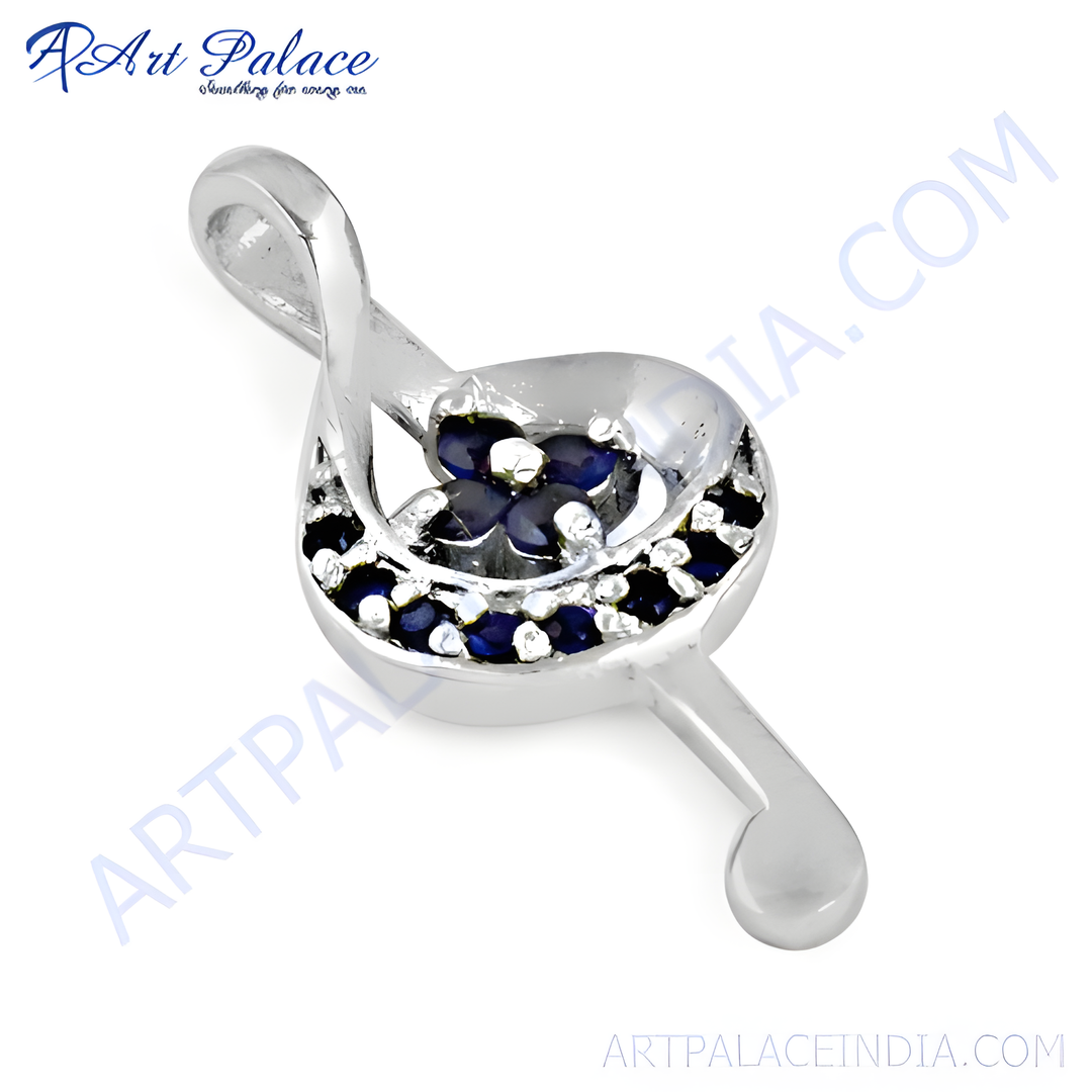 925 sterling silver treble clef pendant with blue sapphire gemstones.