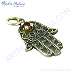 Load image into Gallery viewer, 925 sterling silver Hamsa hand pendant with a red garnet gemstone, intricate openwork design.
